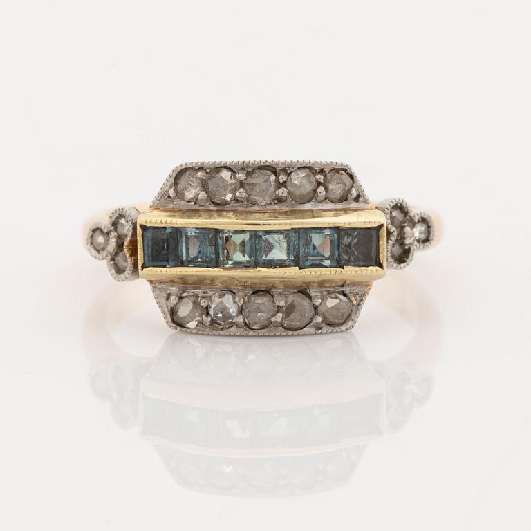 A 14K gold and platinum ring set with green stones and rose-cut diamonds.