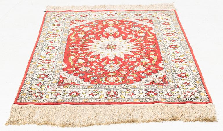 A silk Hereke rug, circa 91 x 63 cm.