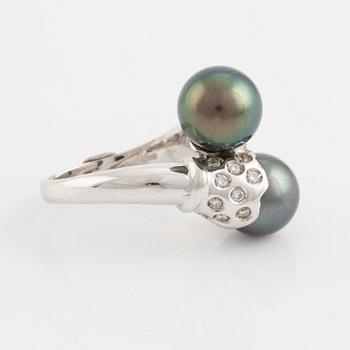 Cultured black pearl and brilliant cut diamond cross over ring.