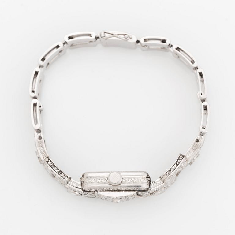 A bracelet/watch in platinum and 18K white gold set with old- and eight-cut diamonds.