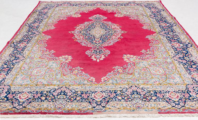 A Kirman carpet, signed, c. 388 x 279 cm.