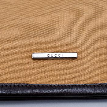 Gucci, a canvas handbag.