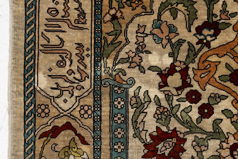A Hereke silk rug, c. 73 x 52 cm.