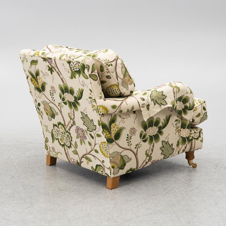 A 'Howard' armchair with footstool, Englesson.
