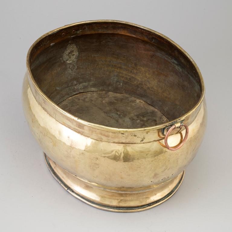 A 18th century brass champagne cooler.