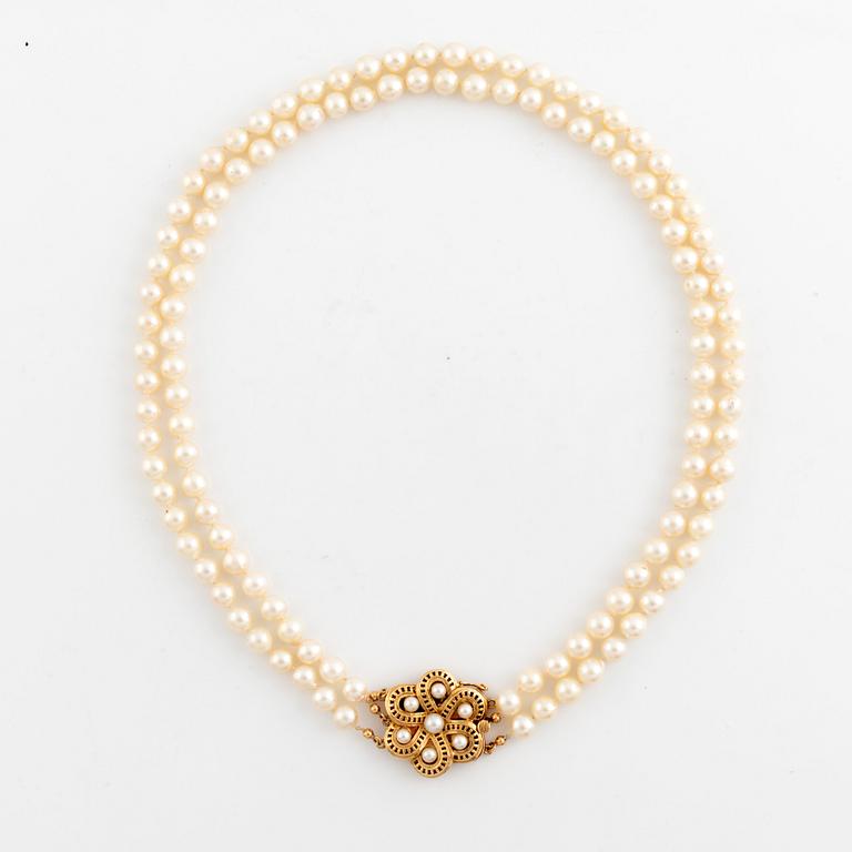 Cultured two strand pearl necklace.