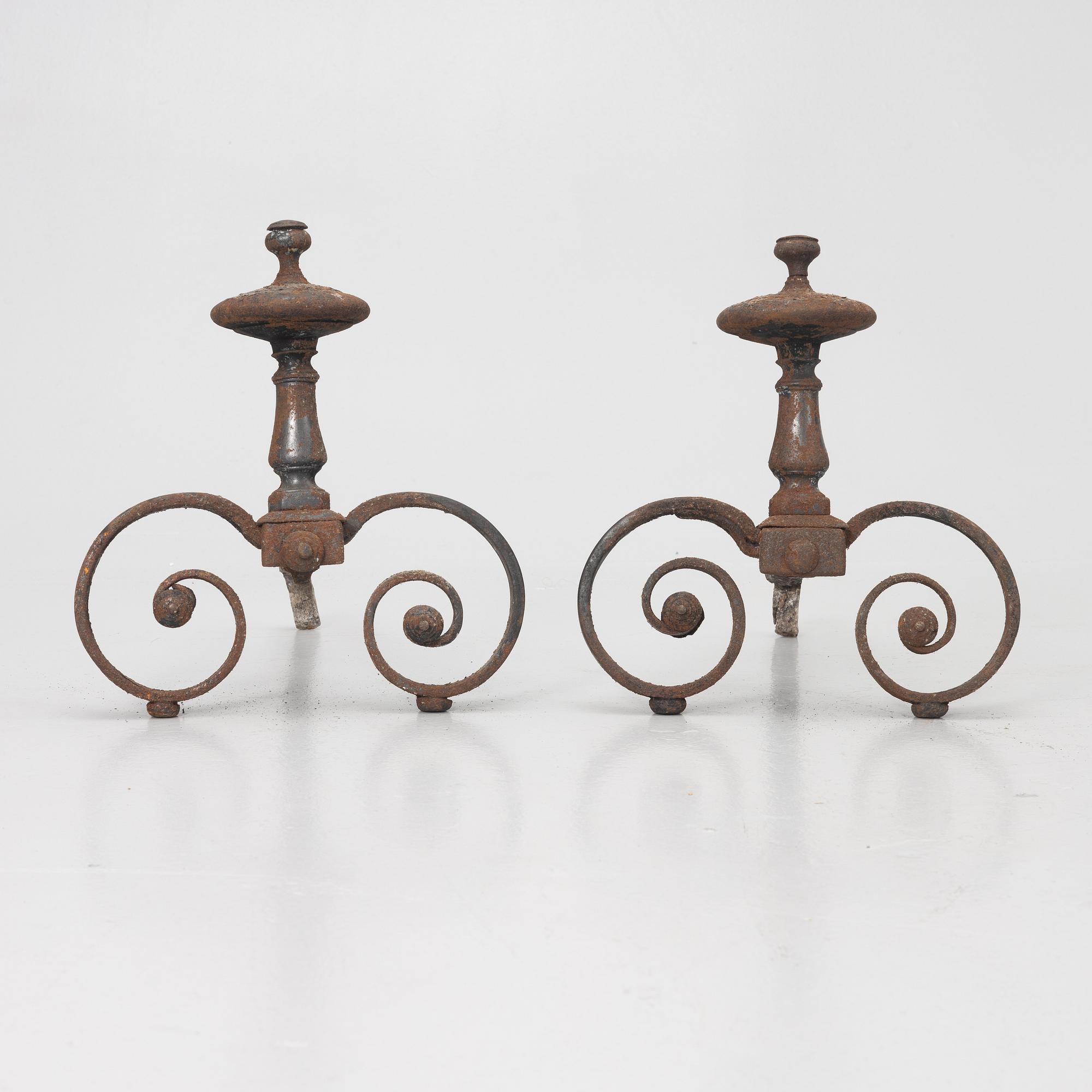 A pair of wrought iron fire dogs.