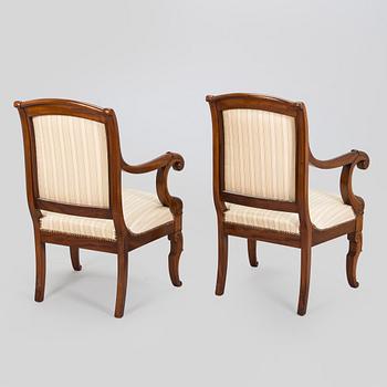 A pair of French open-arm chairs, first half of the 19th century.