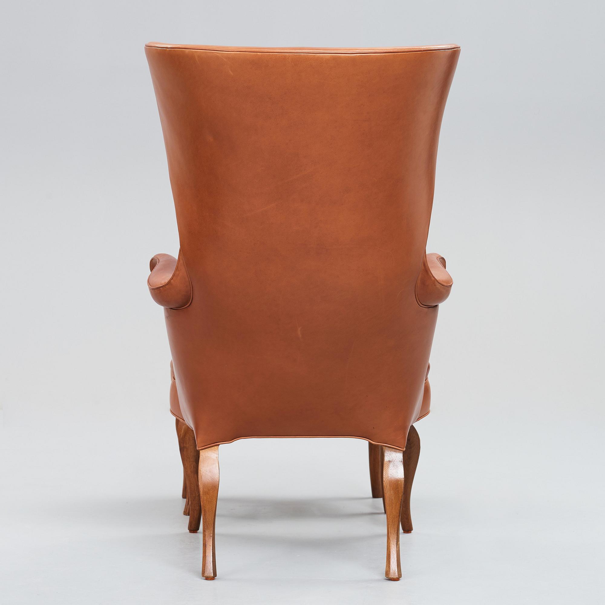 Frits Henningsen, an oak highback chair and ottoman, Denmark 1940's.