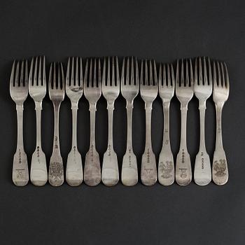 12 English silver forks mainly from the 19th century, some with unidentified crests.