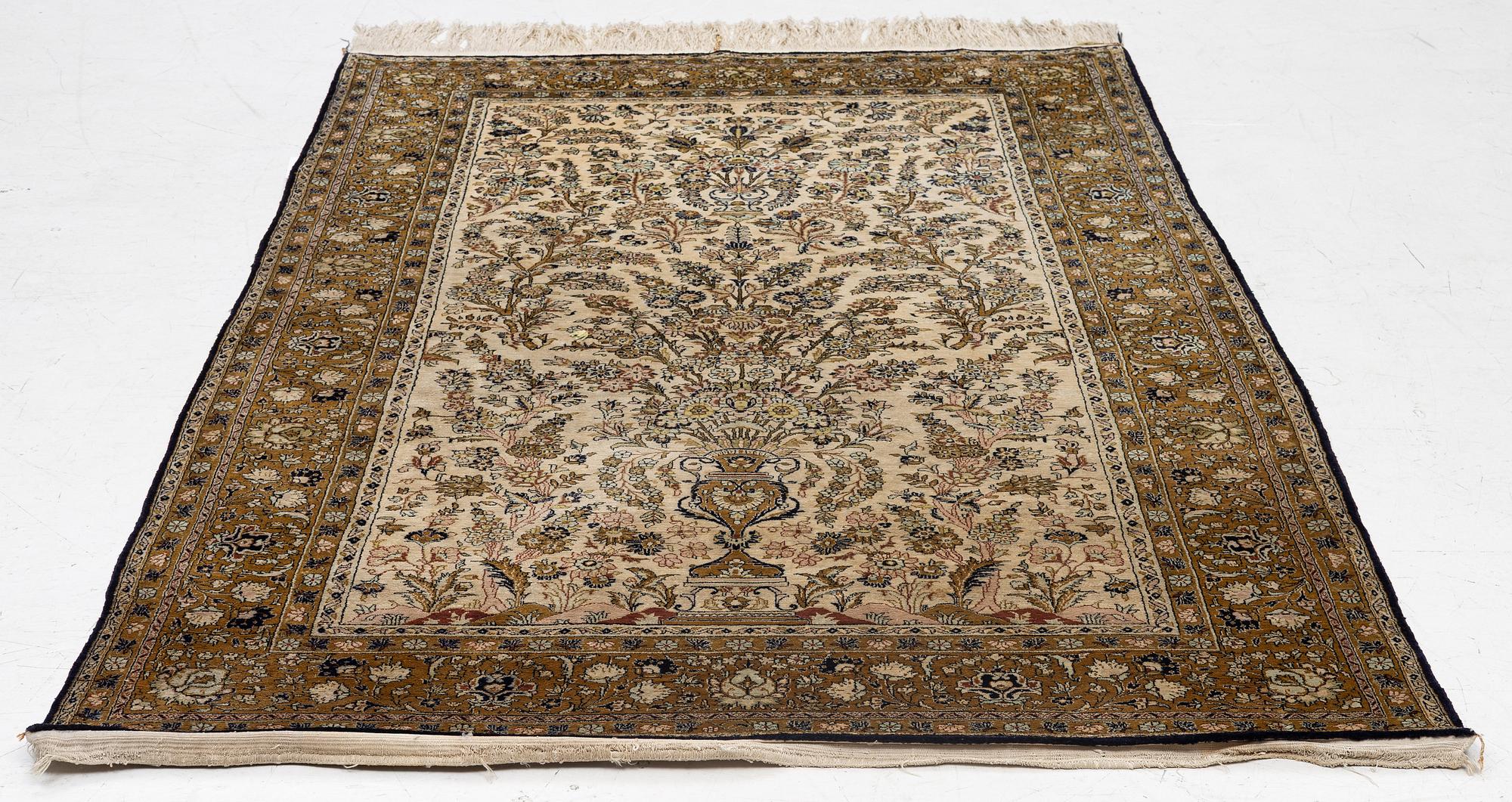 A Ghom, silk rug, c. 215 x 140 cm.
