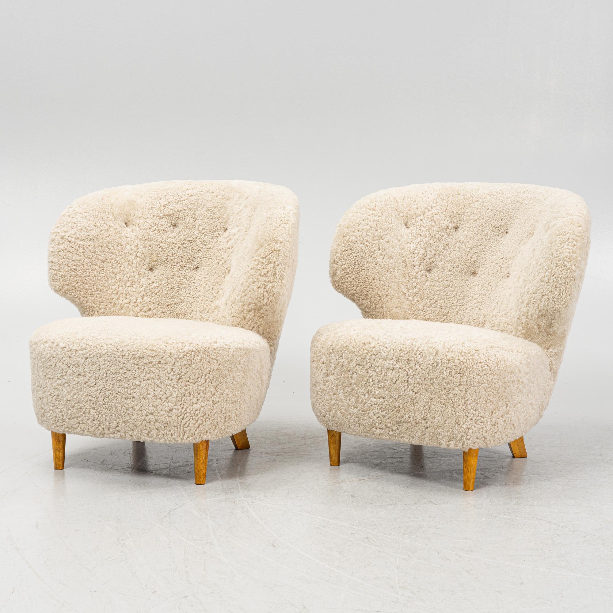 A pair of Scandinavian Modern 1940s cheepskin armchairs.