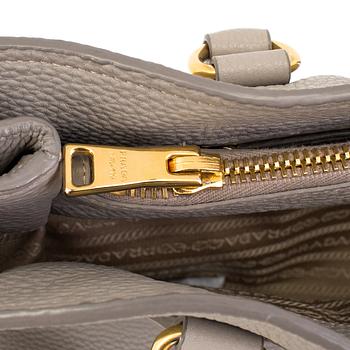 A tote/crossbody handbag by Prada.