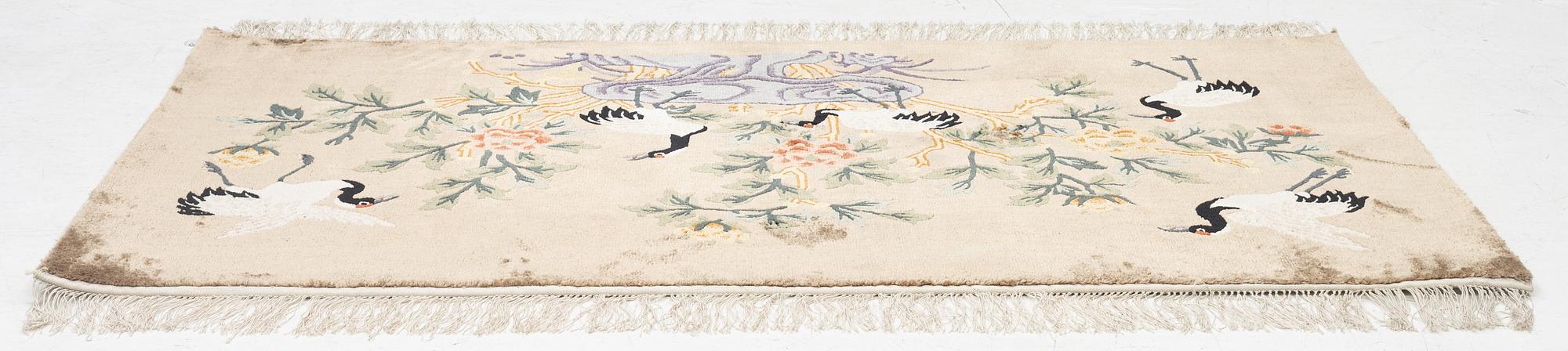 A silke figural rug, China, later part of the 20th century, ca. 92 x 170 cm.