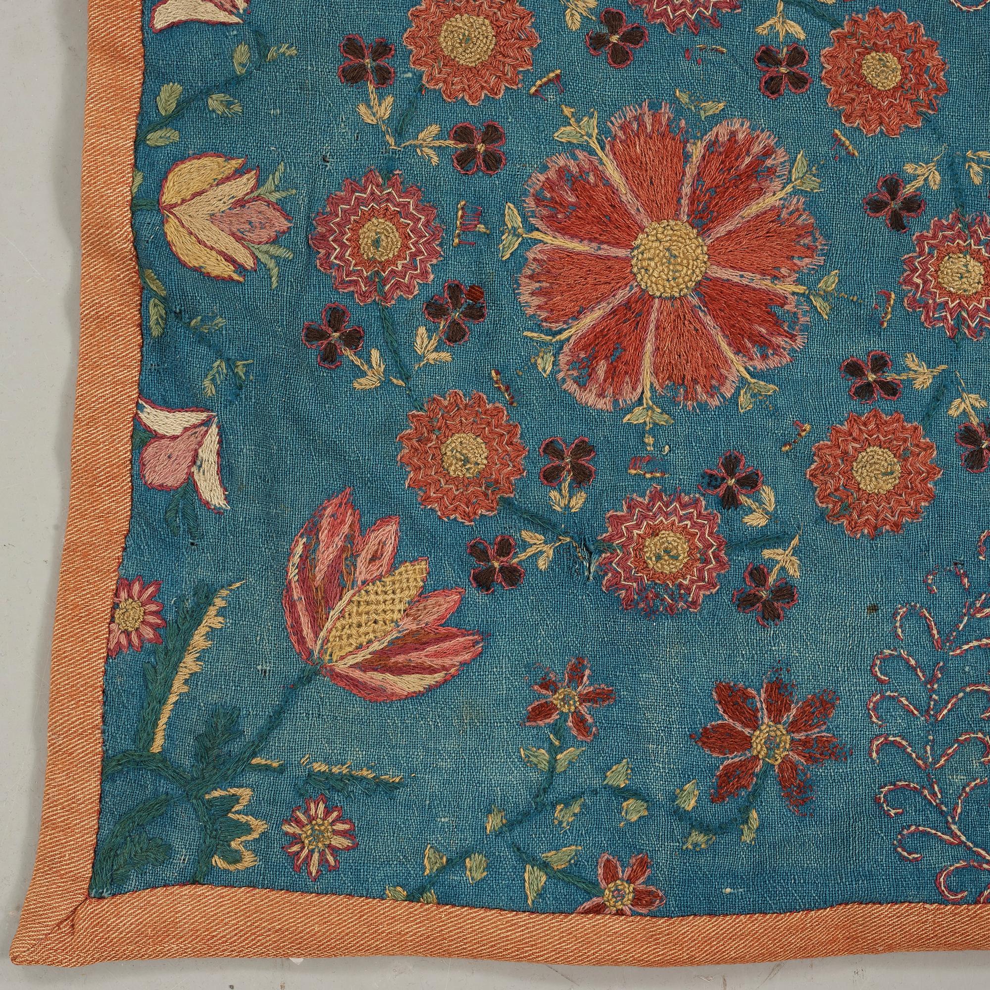 A CARRIAGE CUSHION, embroidered. "Blomsterdyna". 54 x 110 cm. Skåne (Scania, southern part of Sweden) around 1800.