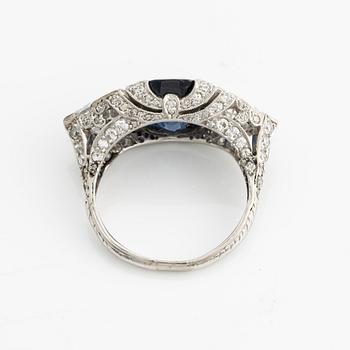 A platinum ring set with a faceted sapphire.