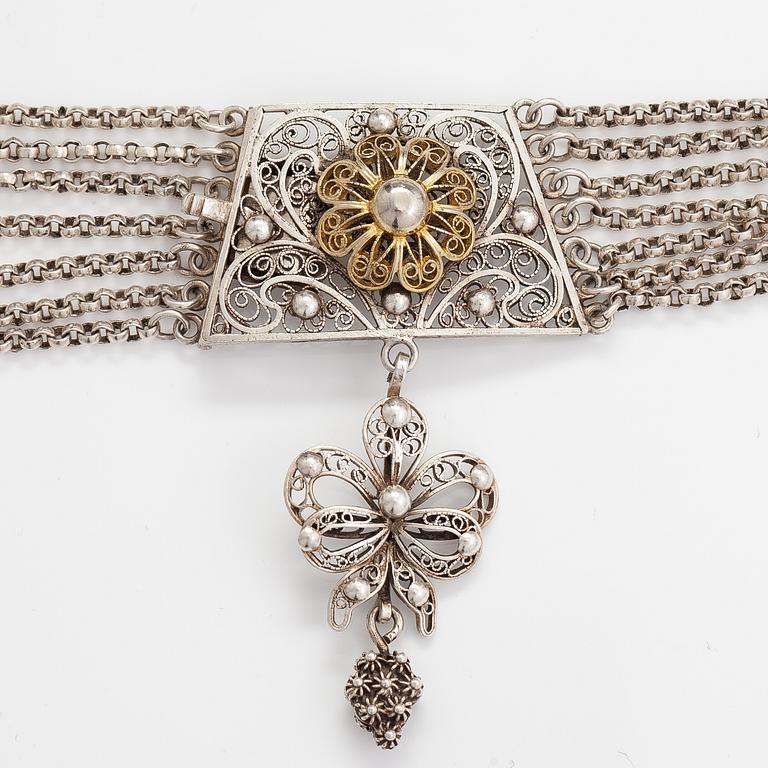 A silver necklace.