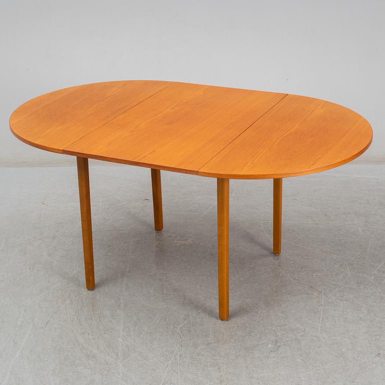 A second half of the 20th century teak veneered dining table.