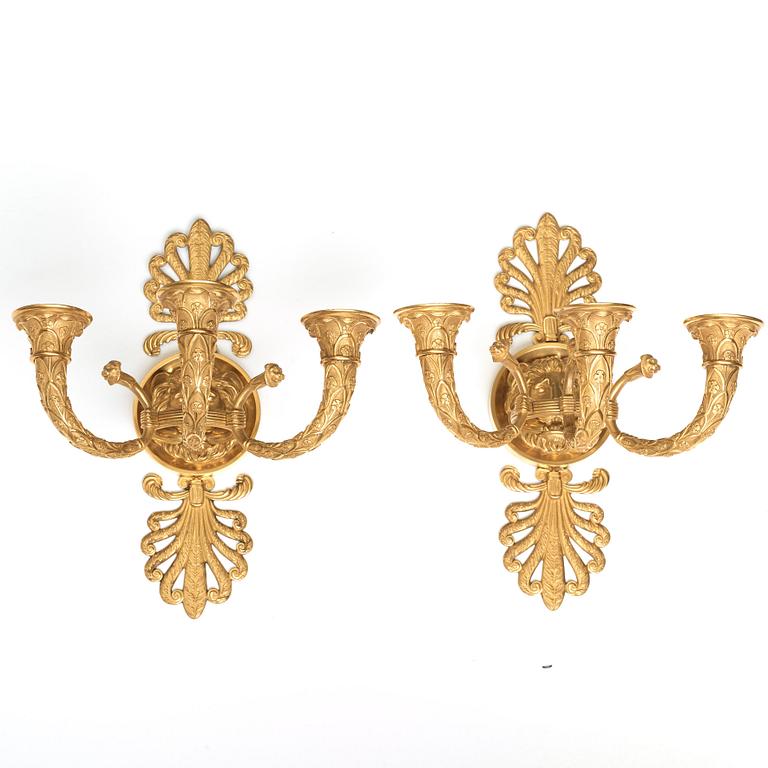 A pair of French Empire early 19th century three-light wall-lights.