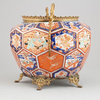 A Japanese plant pot with brass mounts, late 19th century.
