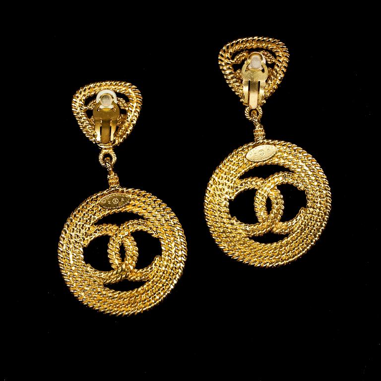 A pair of earclips by Chanel.