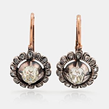 1044. A pair of 9K gold and silver earrings set with old- and eight-cut diamonds.