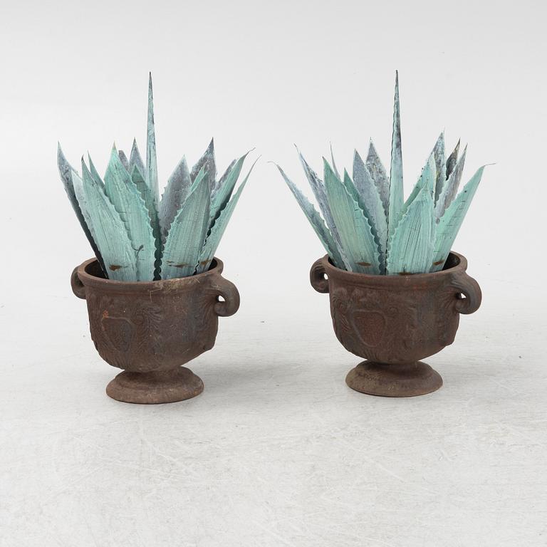 A pair of cast iron garden urns, 20th Century.