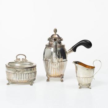 A Swedish silver coffee pot, cream jug and sugar box, Gustavian style, mark of AG Dufva, Stockholm 1911-1912.