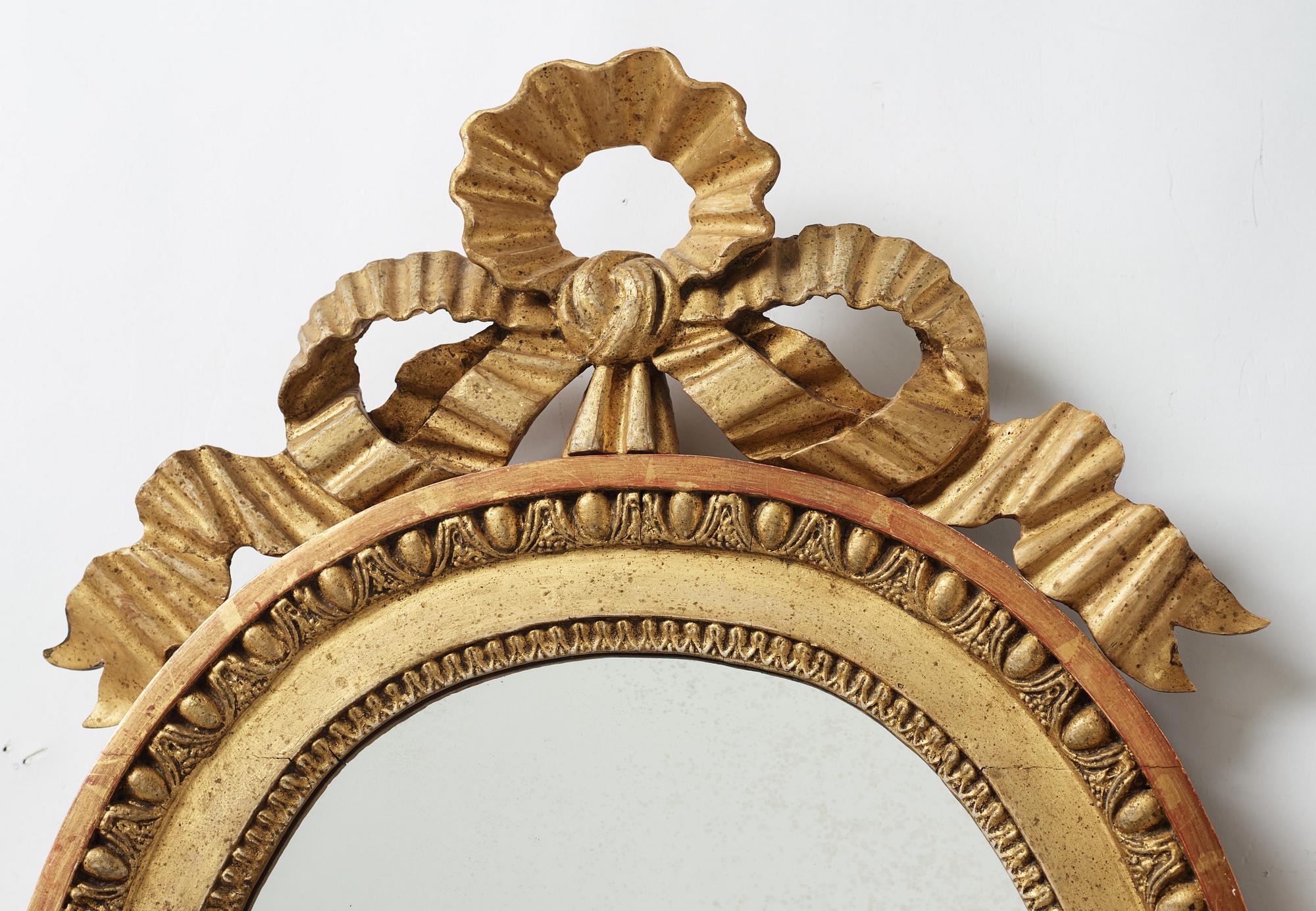 A late gustavian girandole mirror signed by Claes Eric Reding, Karlskrona, (master 1808-1815).
