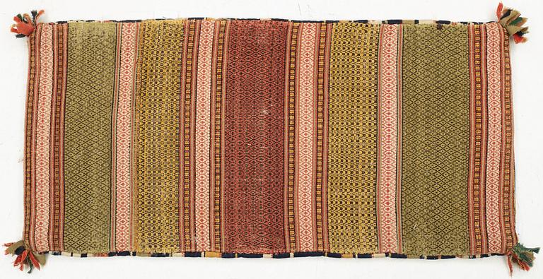 A double-interlocked tapestry carrige cushion from Scania, ca 99 x 49 cm, first half of the 19th century.