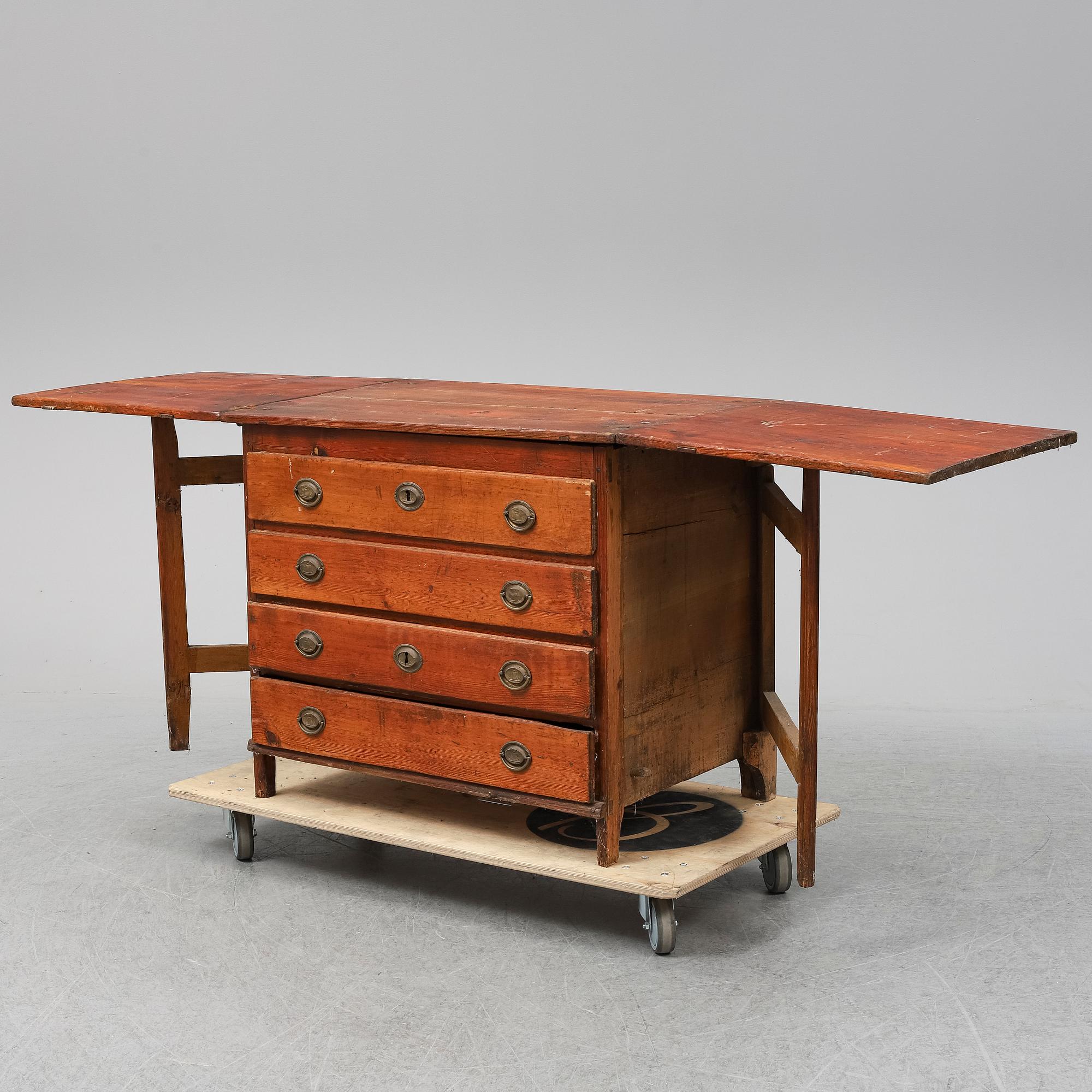 A 19th Century chest of drawers with a table top.