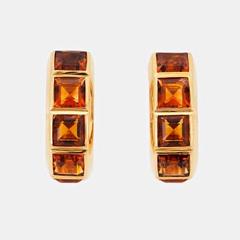 1049. A pair of 18K gold earrings set with step-cut citrines.