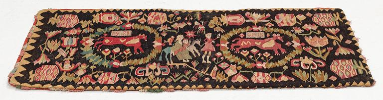A Scania carrige cushion, 'Flykten till Egypten', tapestry weave, c. 98 x 47 cm, Oxie district, signed BAD 1821.