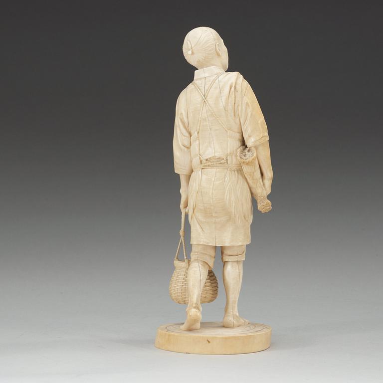 A Japanese ivory figure of a fisherman, Meiji (1868-1912).
