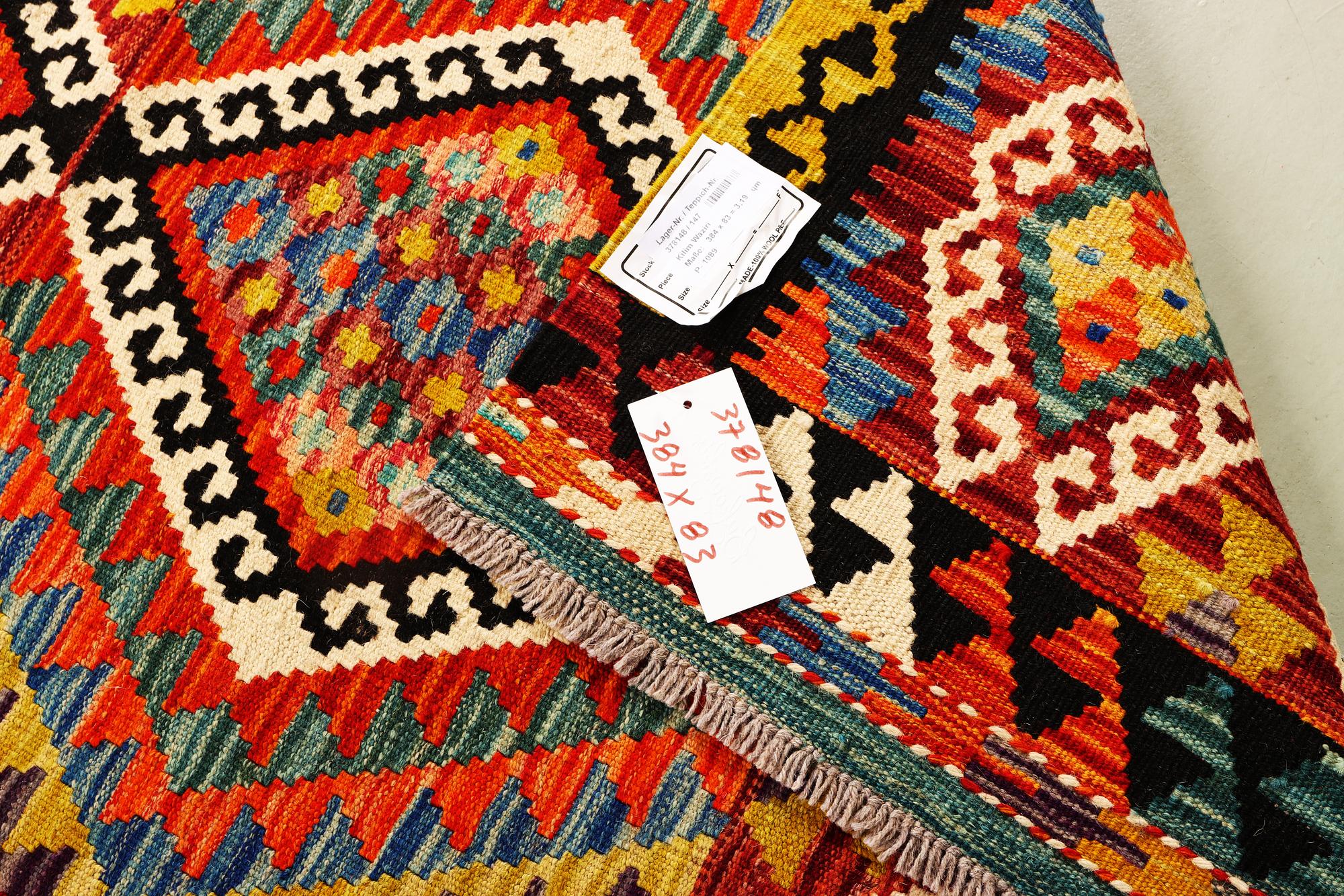 An Afghan Kelim runner, c. 384 x 83 cm.