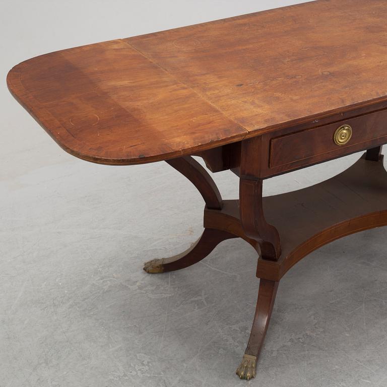 An Empire style mahogany  center table from around the year 1900.