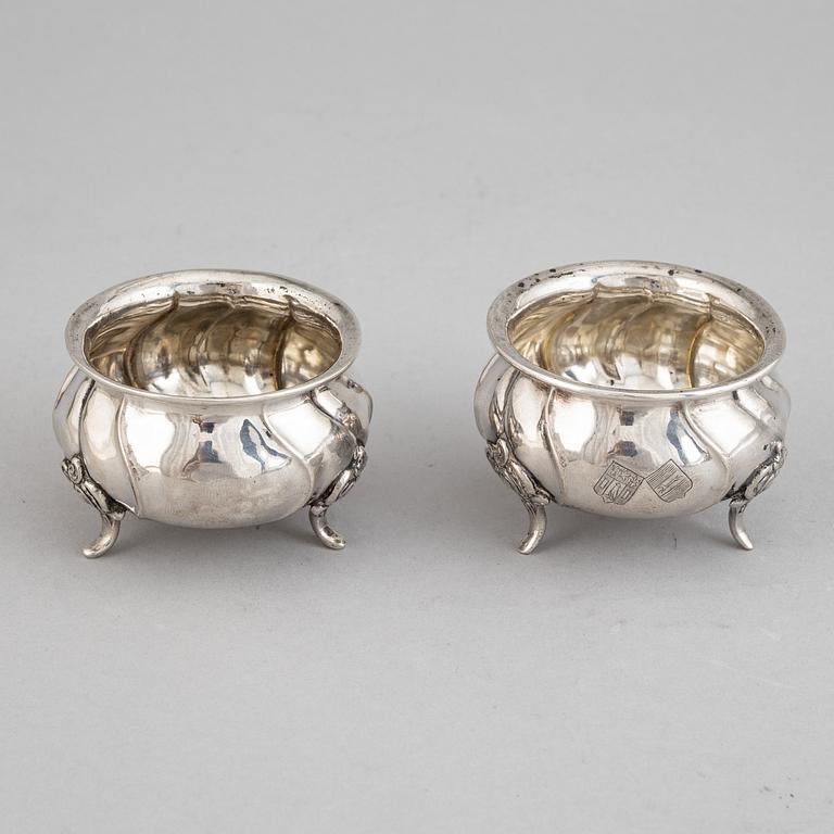 A set of eight rococo-style silver salt cellars, including CG Hallberg 1920.