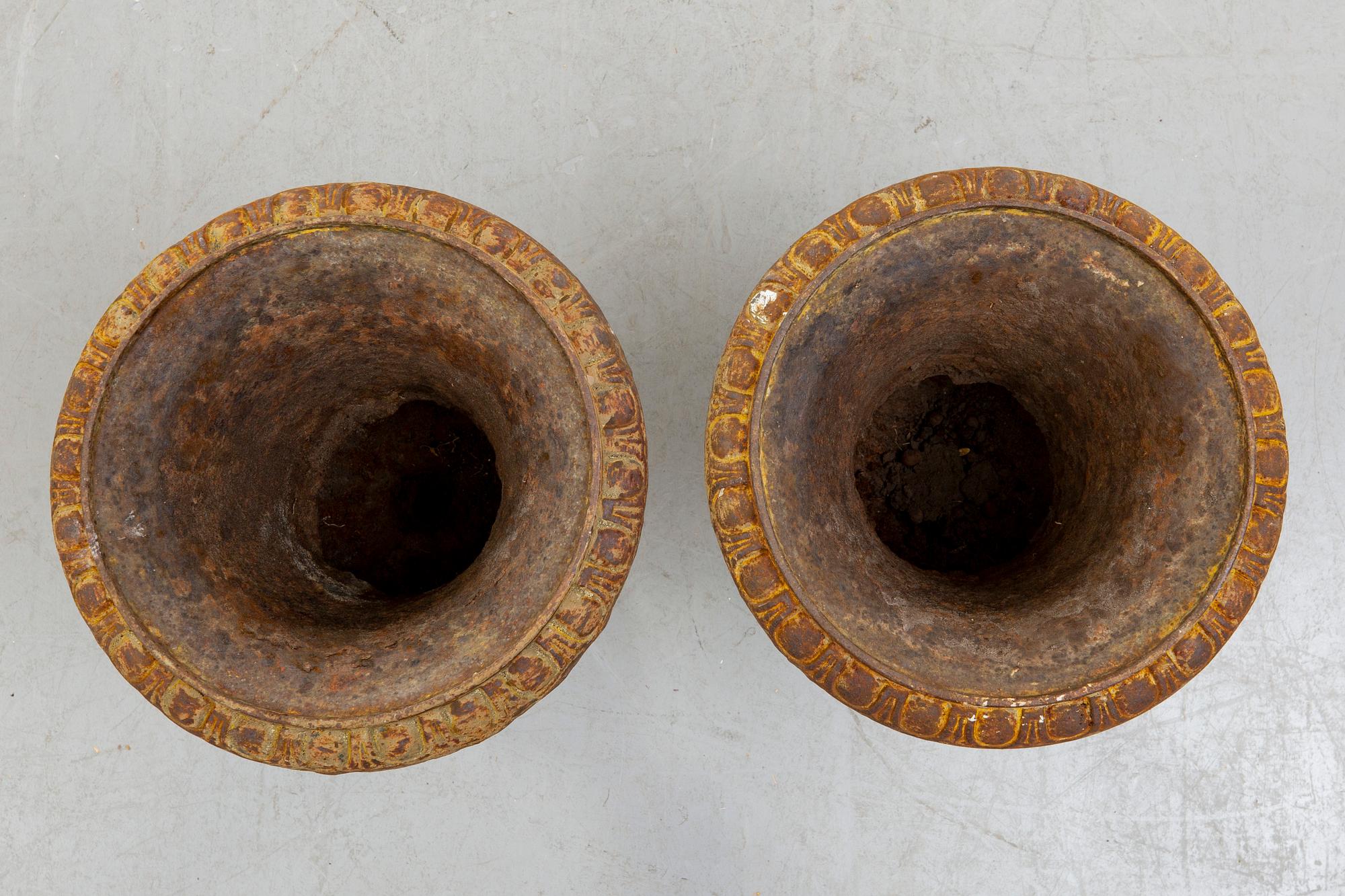 A pair of cast iron garden urns fist half of the 20th century.