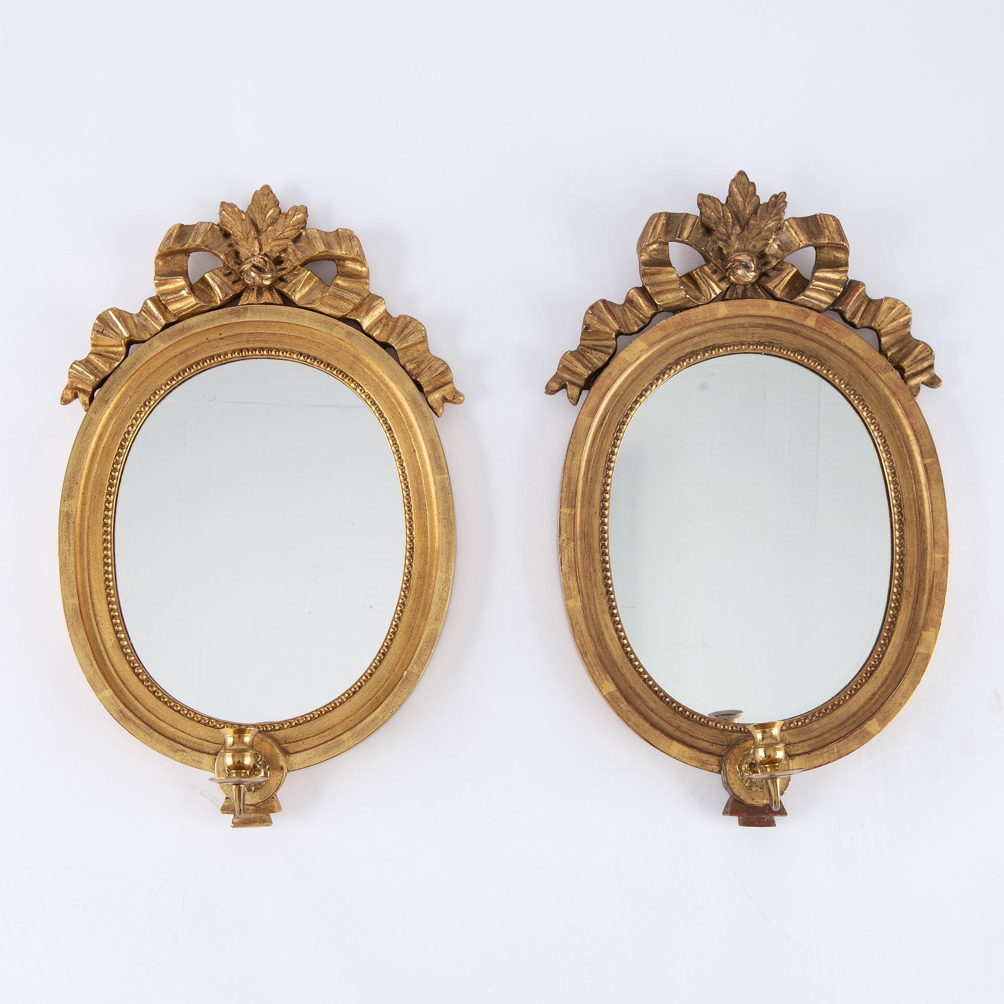 A pair of gilt Gustavian style mirror wall sconces, Stockholm, mid 20th Century.