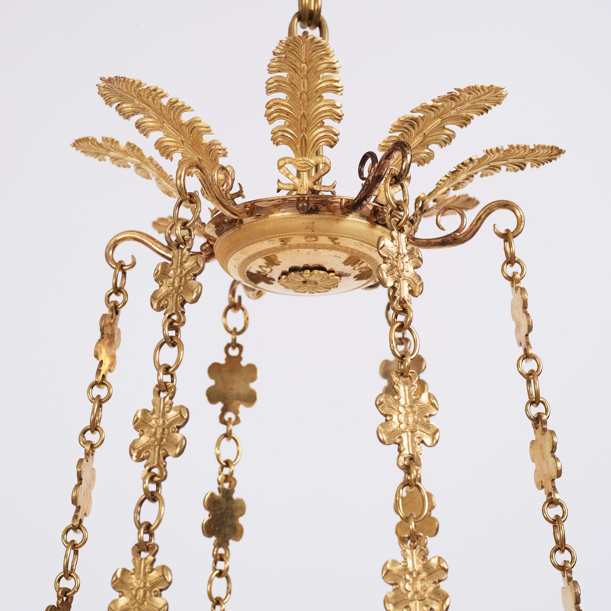 An Empire cut glass and gilded bronze six-light hanging lamp in the manner of Alexandre Guérin.