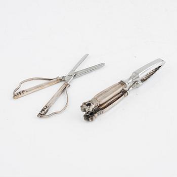 A sterling silver grape scissor and a nutcracker, design Johan Rohde, Georg Jensen, Copenhagen, post 1945.