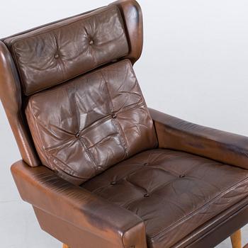 AN ARMCHAIR WITH STOOL BY SKIPPER MÖBLER, 1960/70.