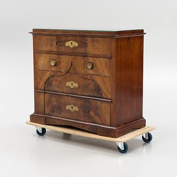 A mahogany veneered Empire chest of drawers, first half of the 20th Century.
