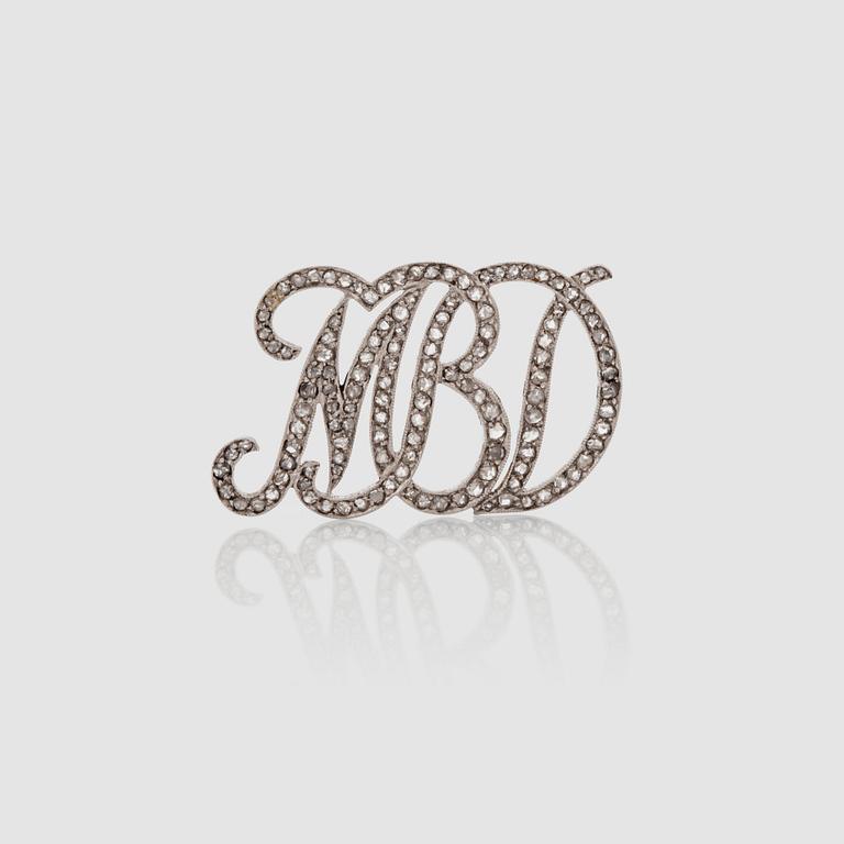A brilliant-cut diamond brooch with initials MBD. Possibly by David Andersen.