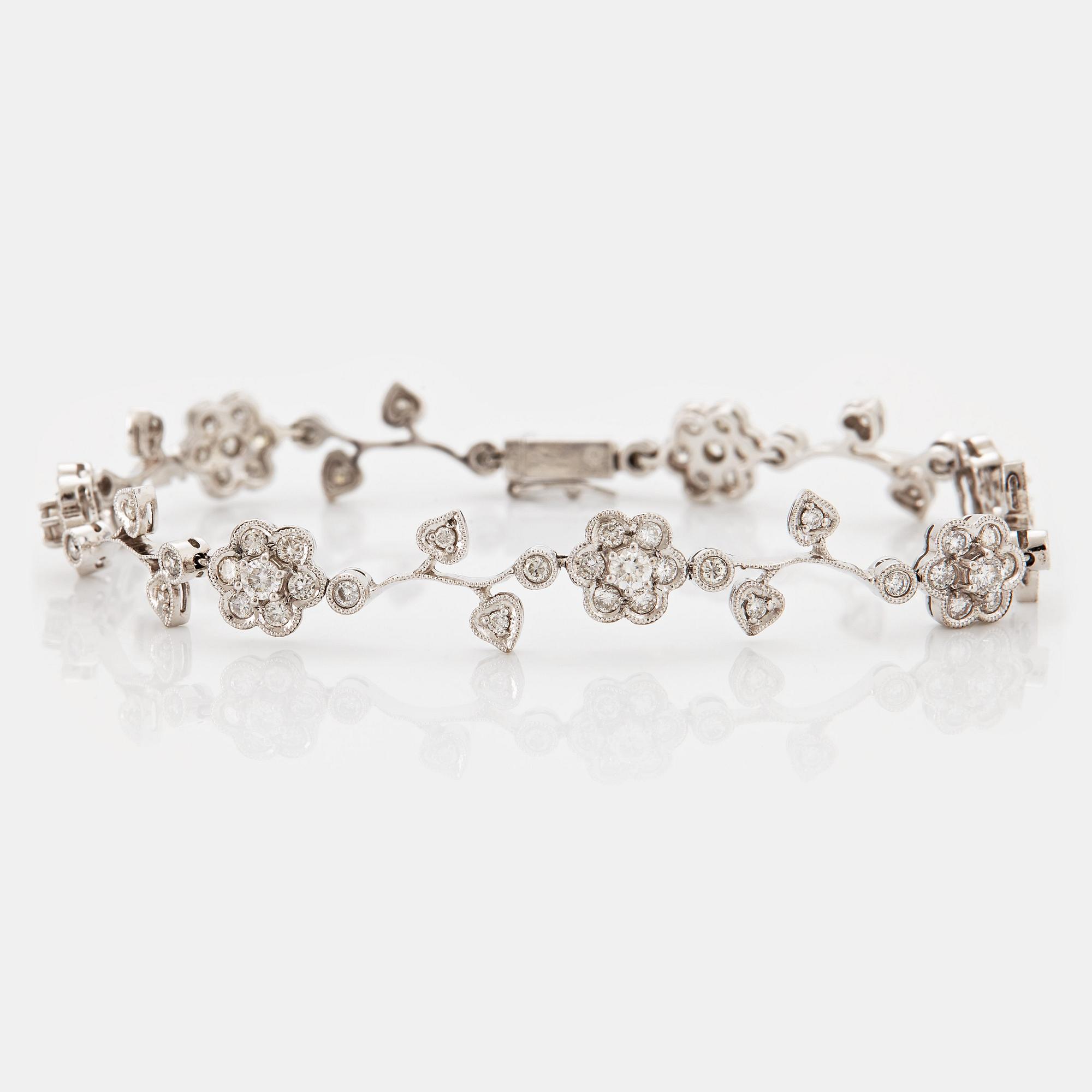 An 18K white gold bracelet set with round brilliant-cut diamonds.