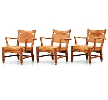 346. SCANDINAVIAN MODERN, a set of three mid 20th century mahogany and brown leather easy chairs.