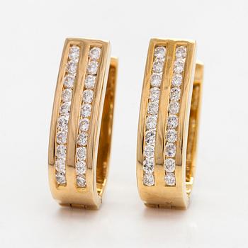 A pair of 18K gold earrings with diamonds approx 0.60 ct in total.