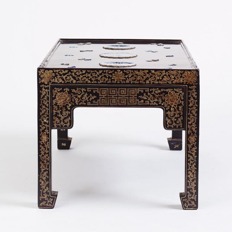 A Chinese black lacquered table with porcelain placques, presumably first half of the 20th century.