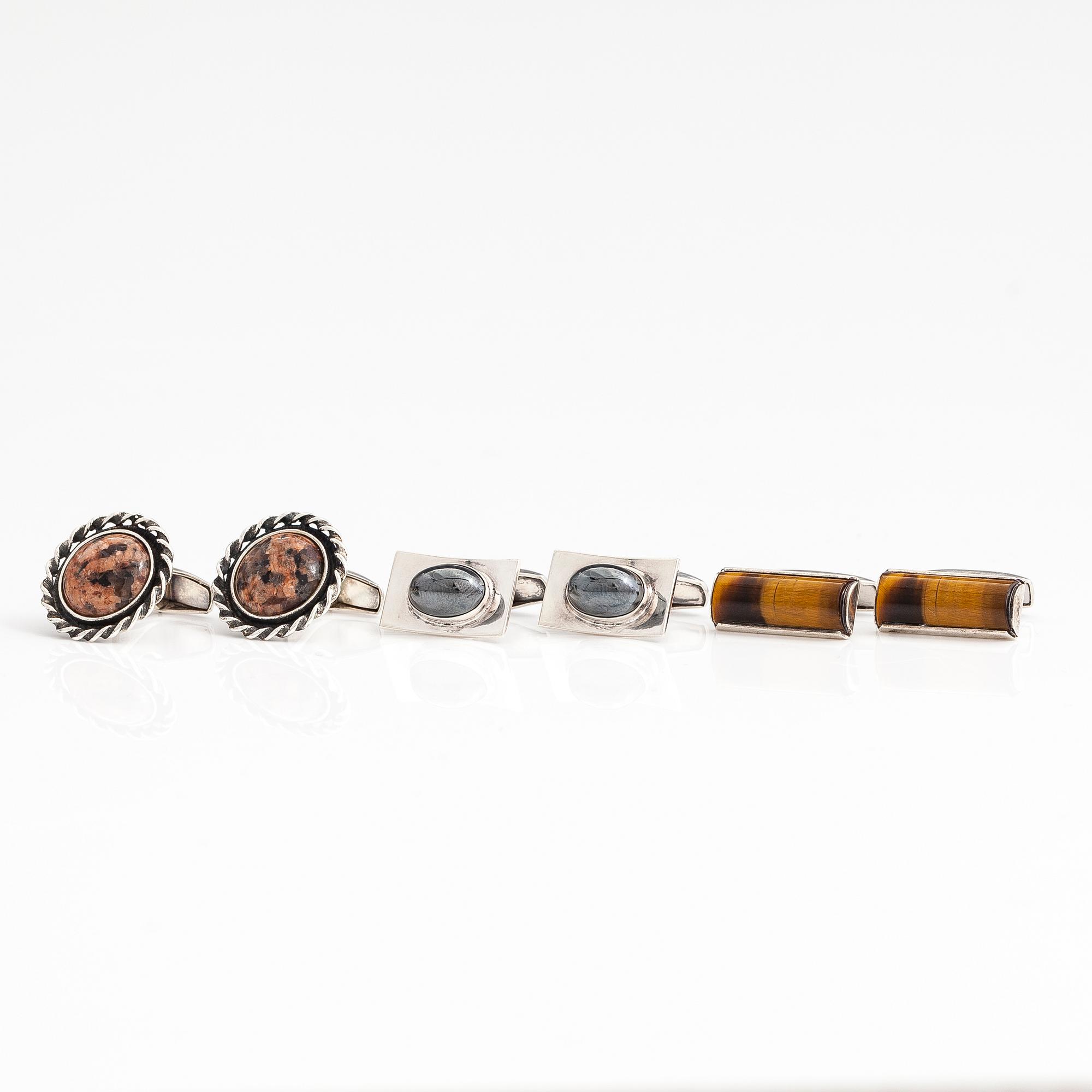 A set of three pairs of silver cufflinks with hematite, tigers eye and granite. Turun Hopea and Osvald Mättö.