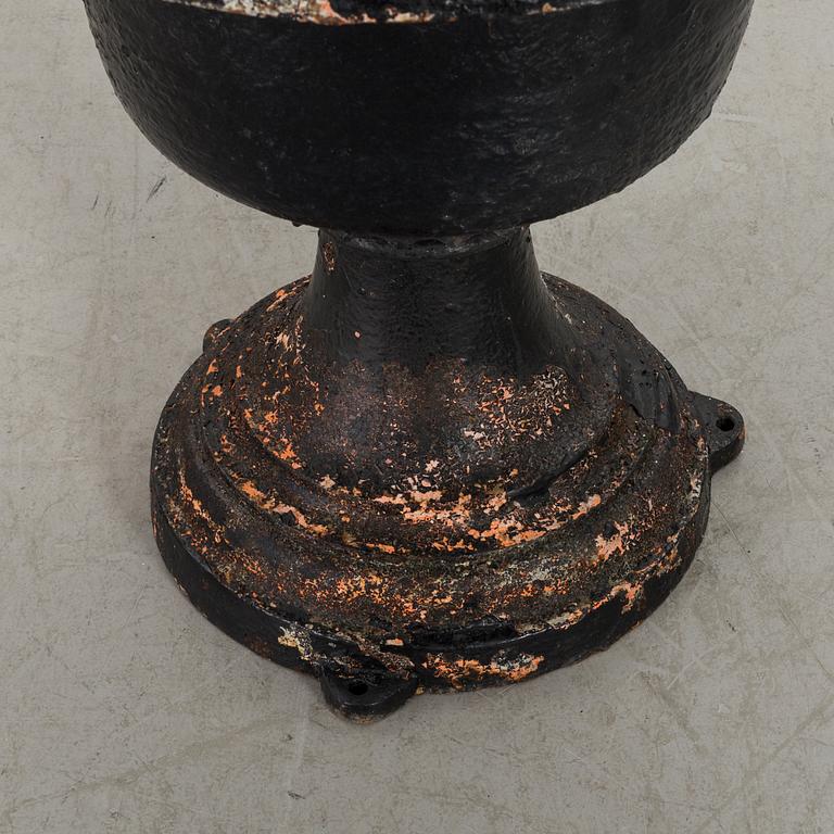 A CAST IRON GARDEN URN.